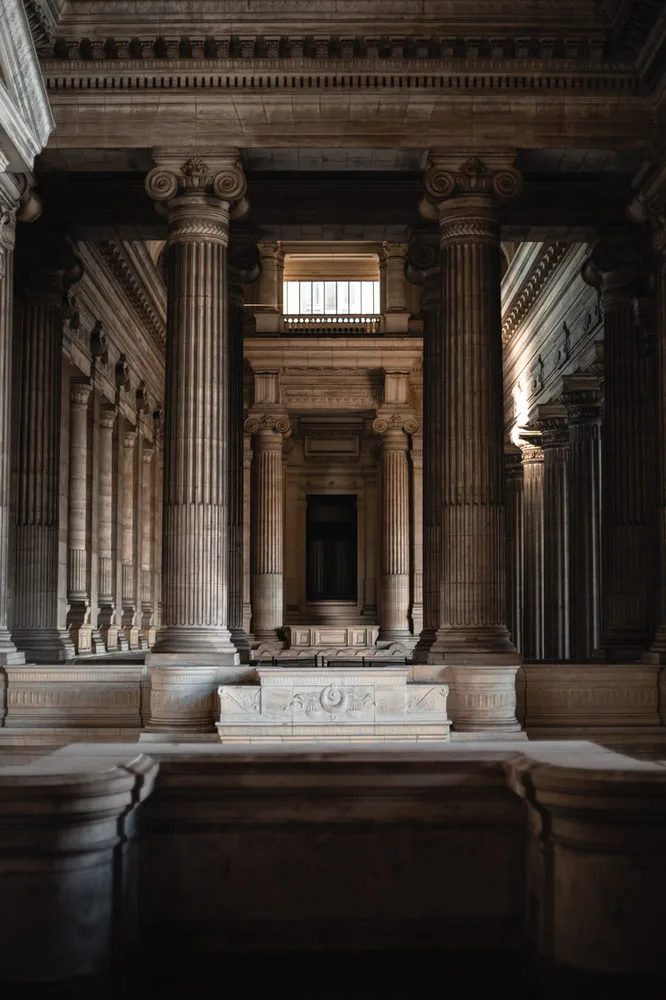 Interior hallway with tall stone columns.