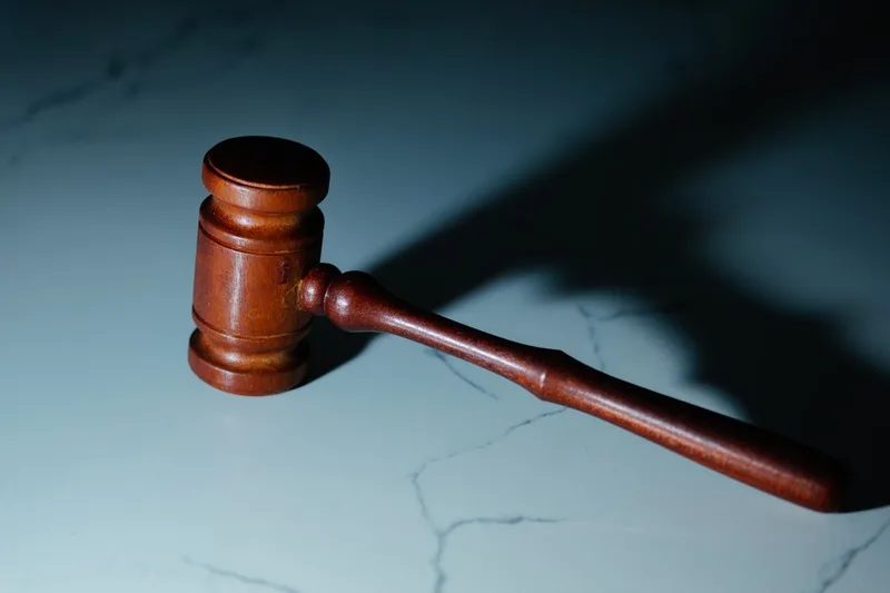 Wooden gavel on a light stone surface