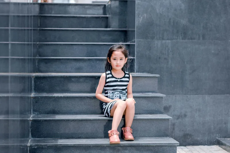 Child sitting on stone steps