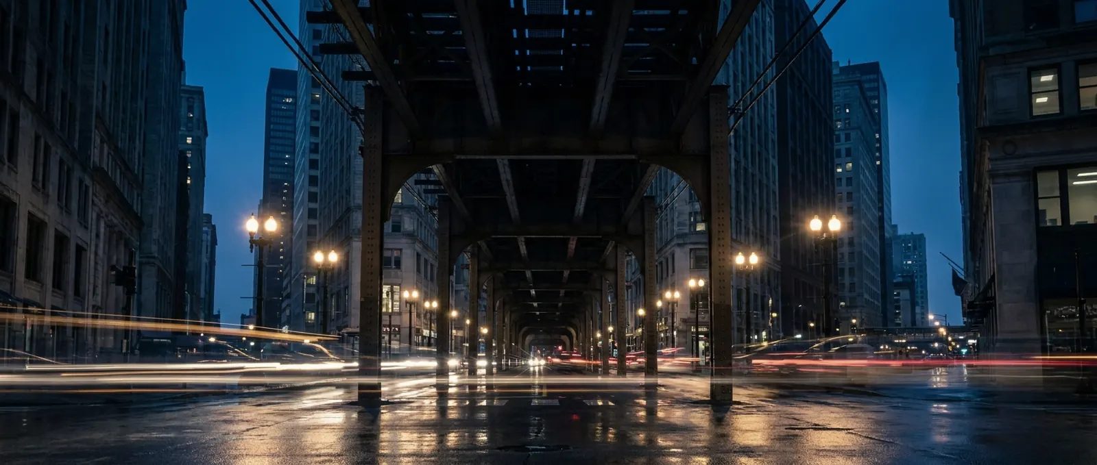Illustration: elevated train tracks over a Chicago Loop street at dusk