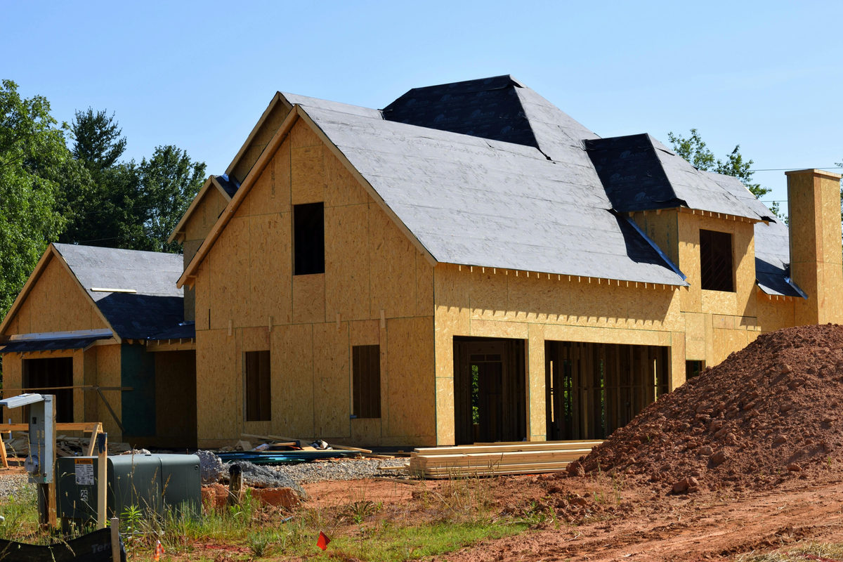 House under construction with exposed wood sheathing