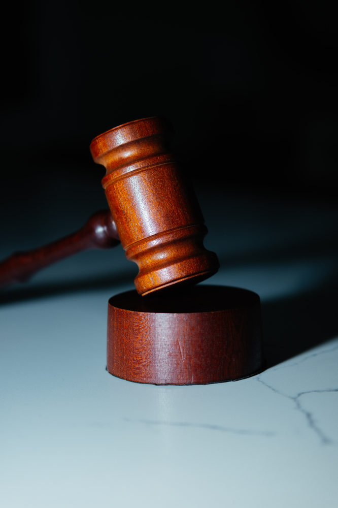 Wooden gavel above a round block.