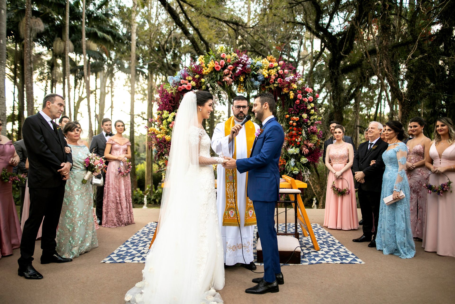 Outdoor wedding ceremony under a flower arch