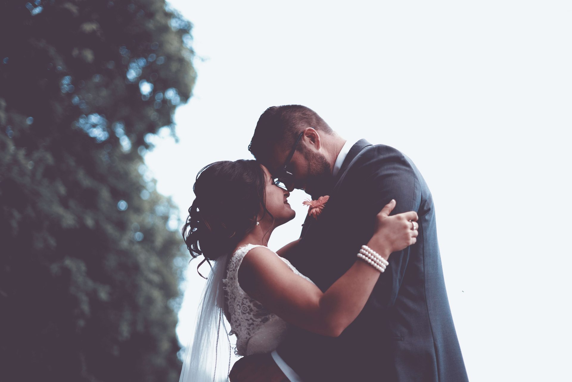 Bride and groom embracing outdoors