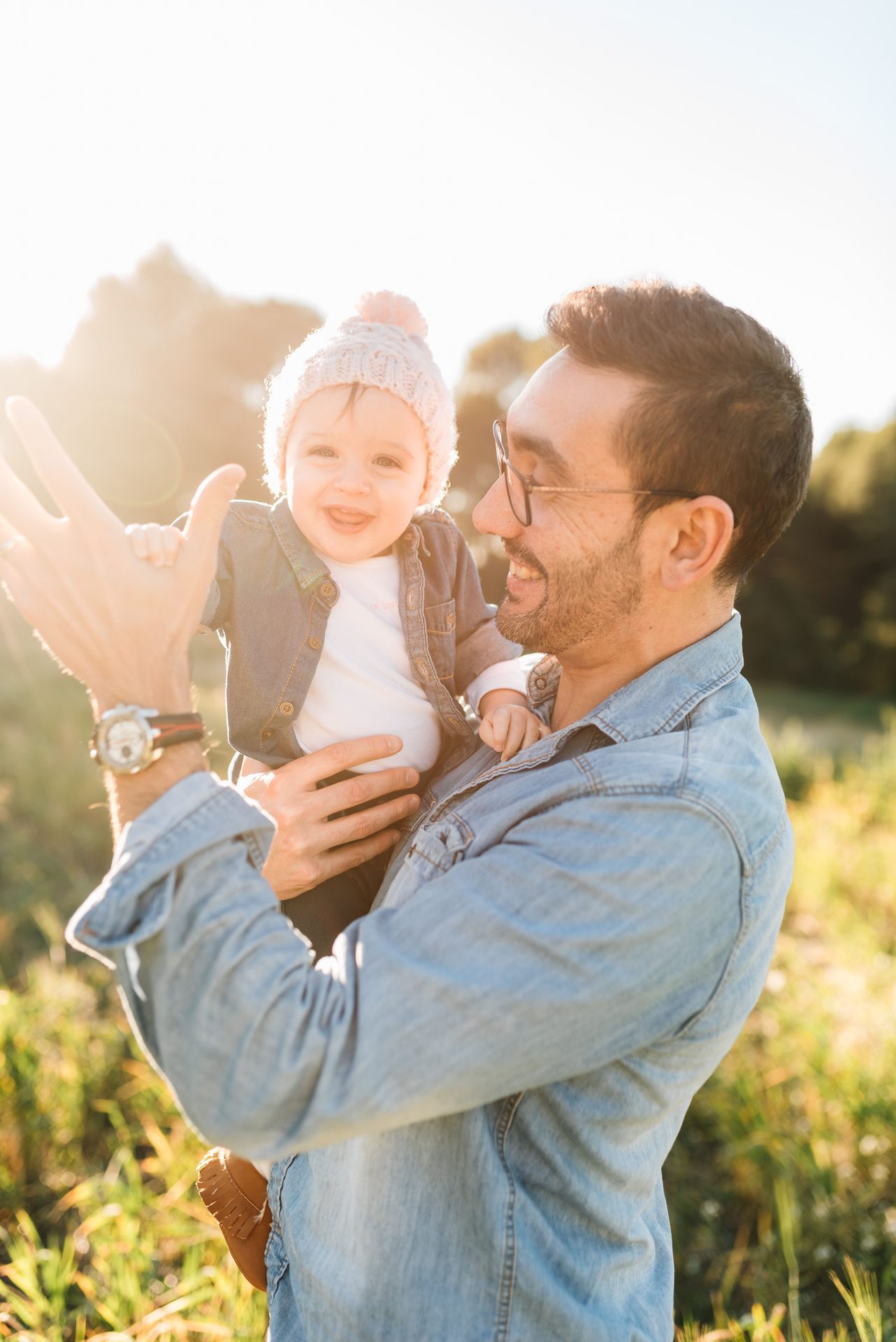 Father holding son in field