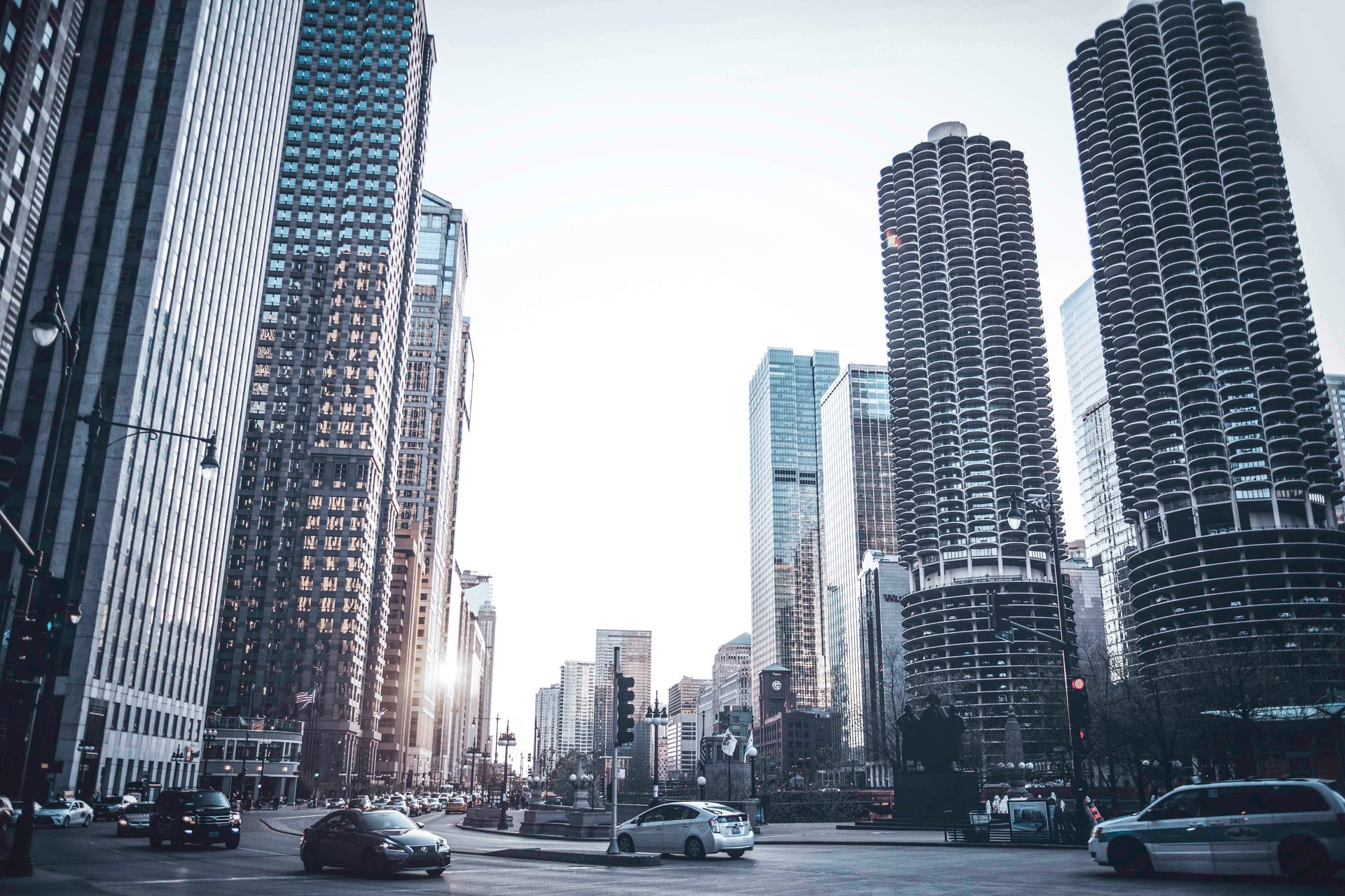 Black and white view of a downtown Chicago street with the Marina City towers