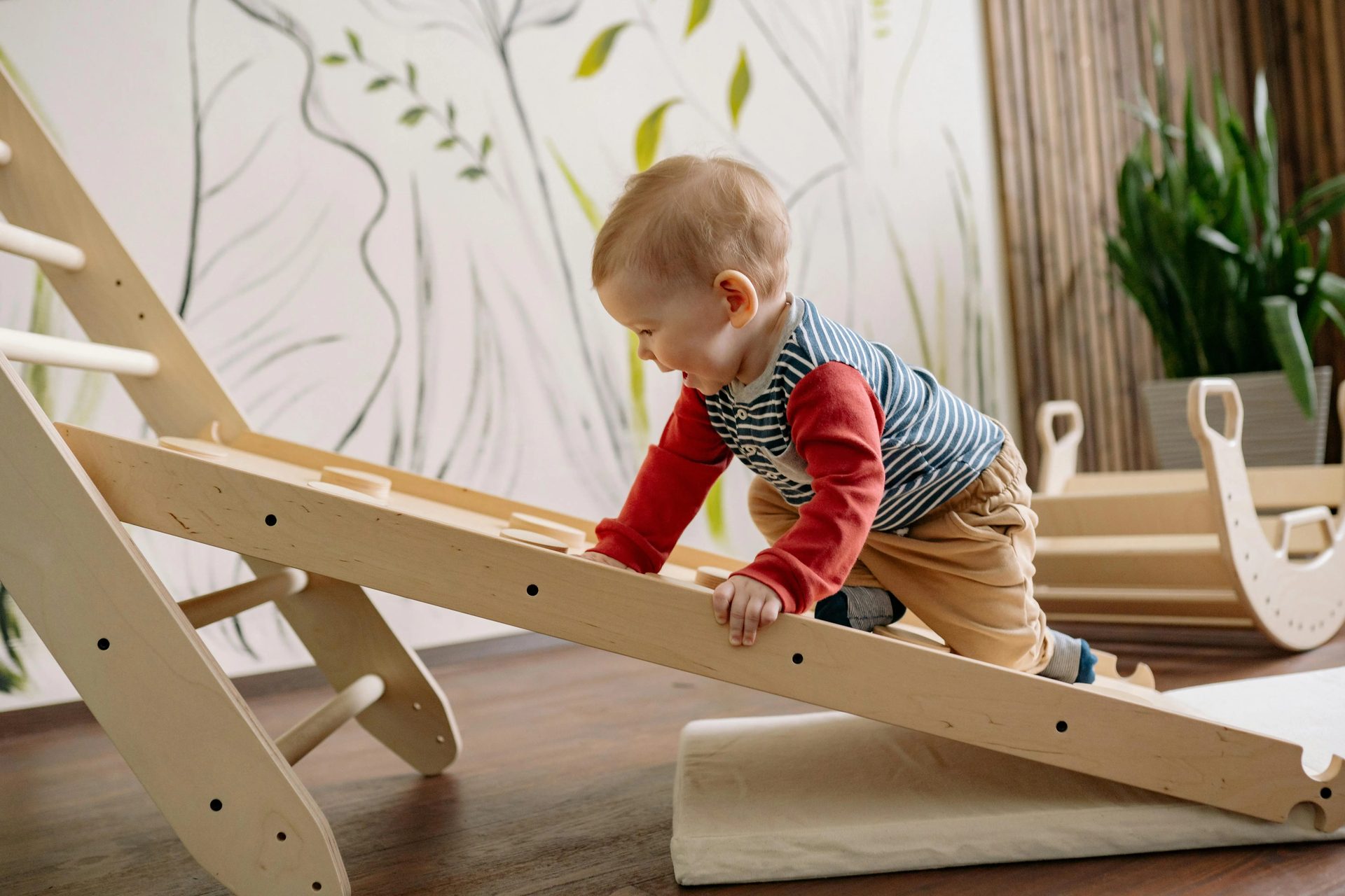 toddler playing on moving boxes and ladders