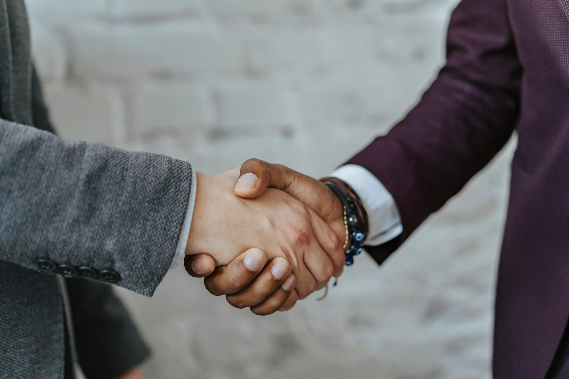 Two people in jackets shaking hands.