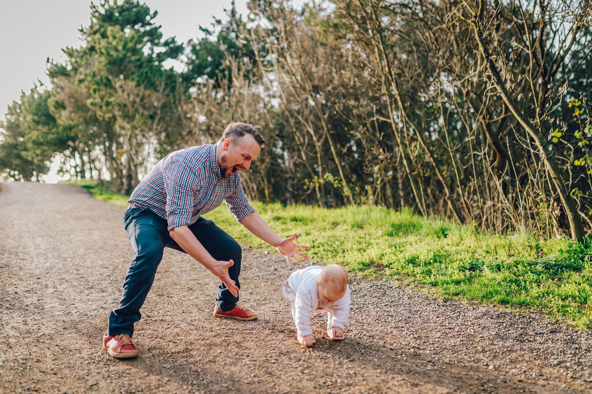 father watching son take first steps