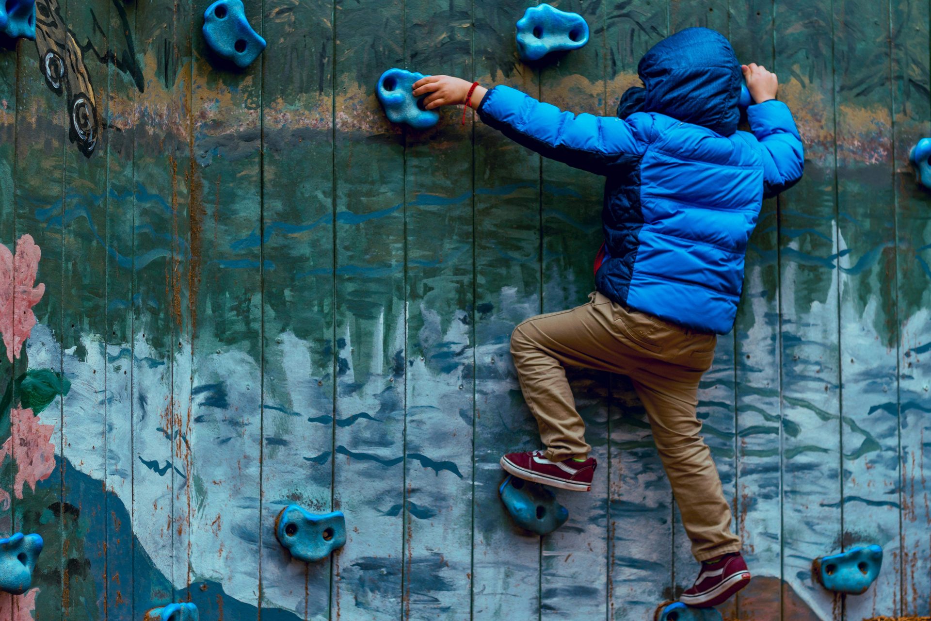child climbing rock wall