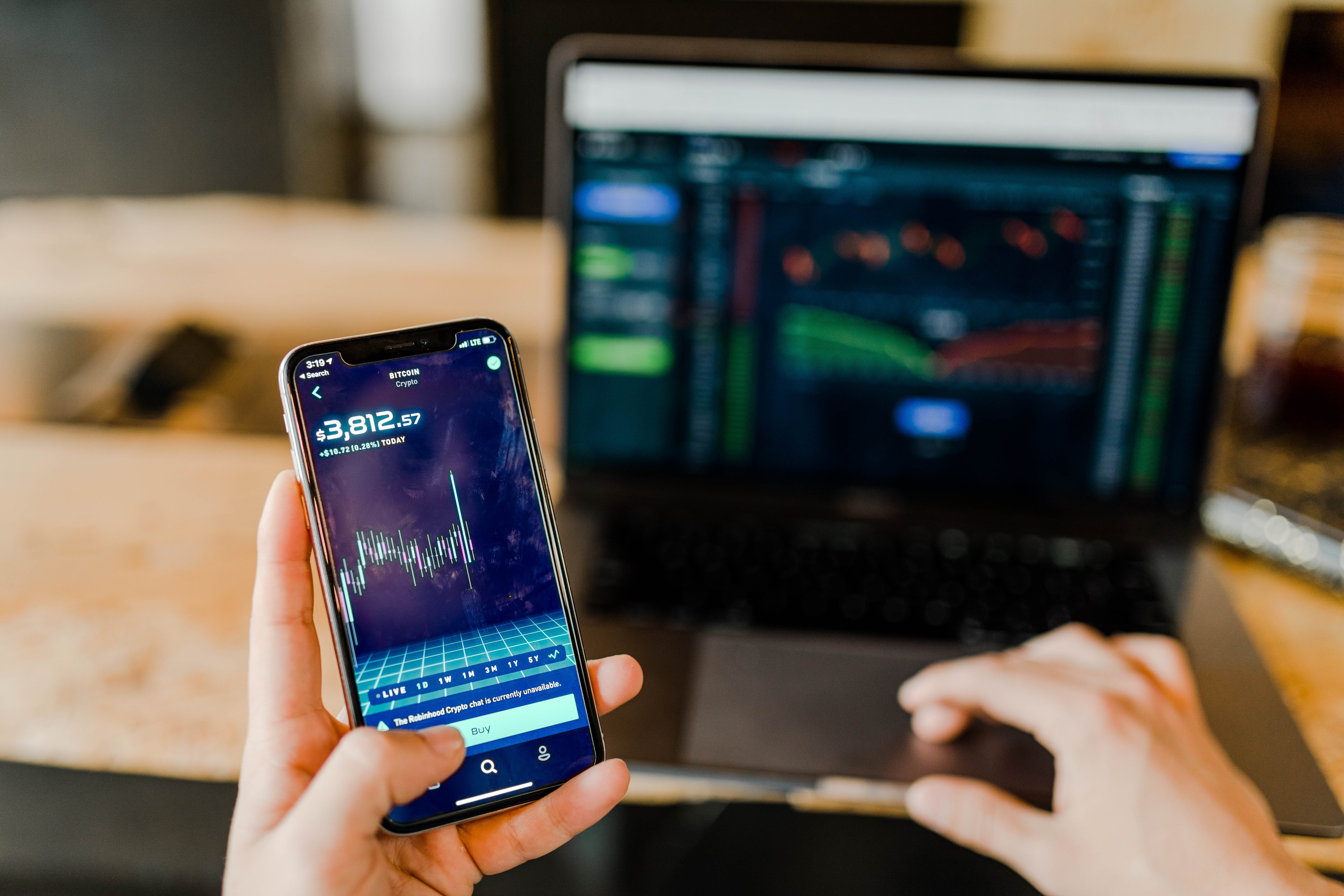 person review finances on phone and laptop