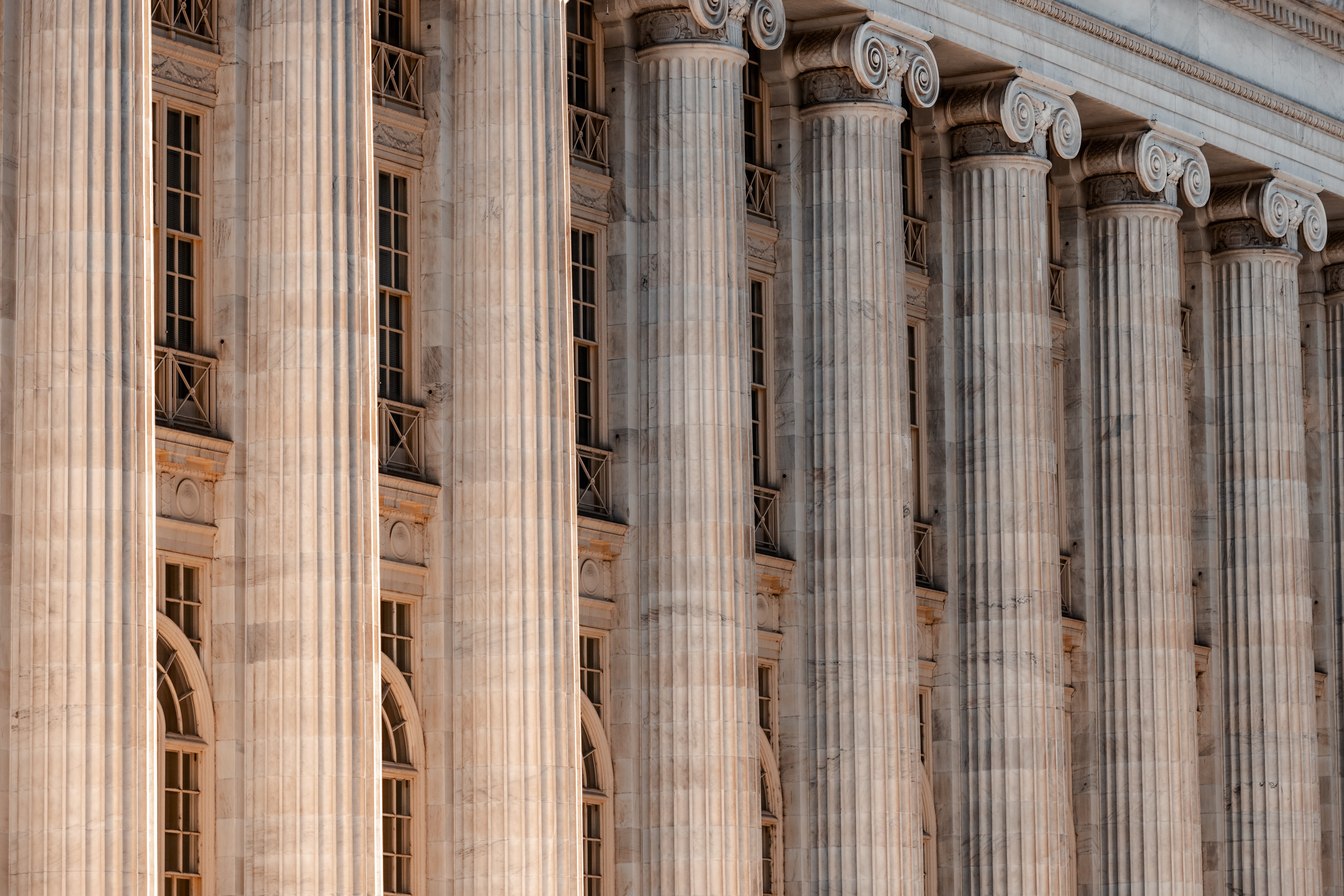 A row of tall stone columns across a building facade.