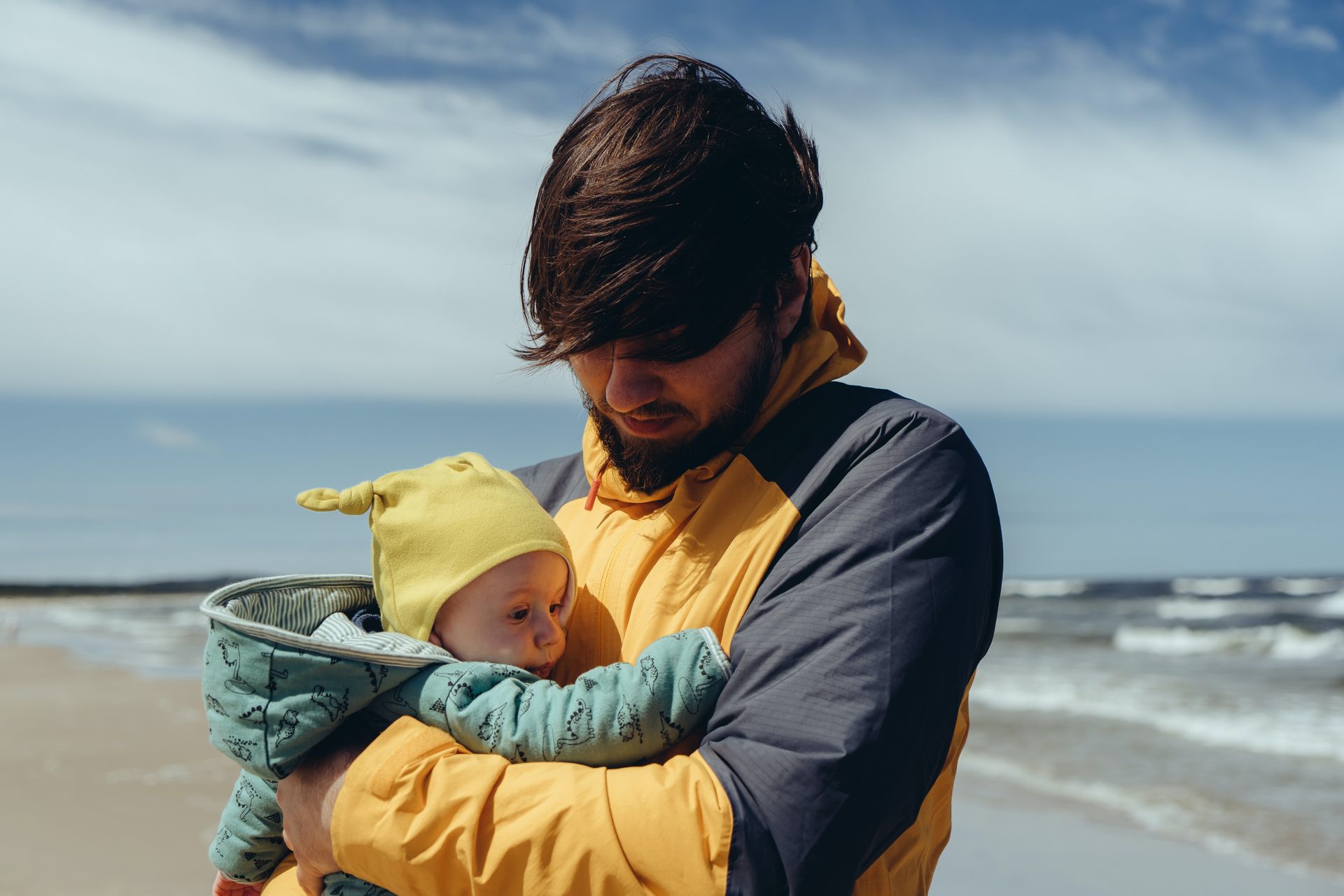 father on beach with baby